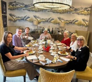 People sit around a table enjoying a private christmas dinner at Cavendish Park, in Evesham