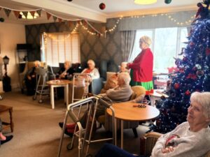 Residents enjoying time together by the Christmas tree at Oaktree Court Care home in Somerset.