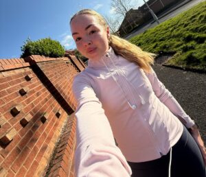 a girl walking and smiling at Majesticare Luxury Care Homes.