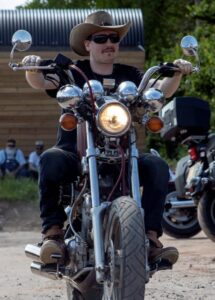 a man sat on a motorbike.